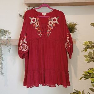Red bohemian dress with flower designs.